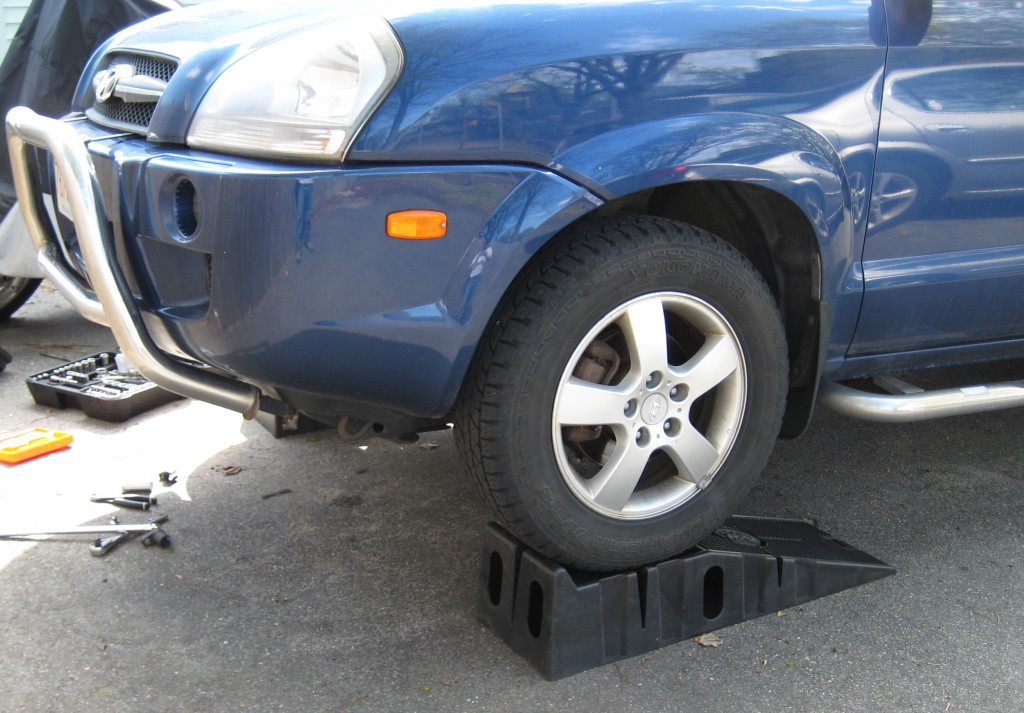 Elevate the front of your Tucson with a jack and jackstands or RhinoRamps. Remember to chock your rear wheels.